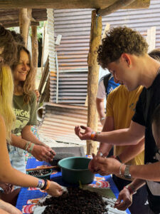 Travelers learning the bean-to-bar chocolate making process with a local family in Guatemala