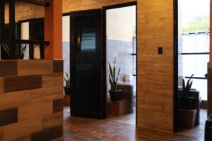 Modern shared bathroom entrance in Cayala mixed dorm at Greengo’s Hotel Guatemala