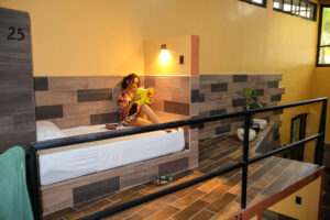 Capsule beds with privacy curtains and personal fans in Cayala mixed dorm at Greengo’s Hotel