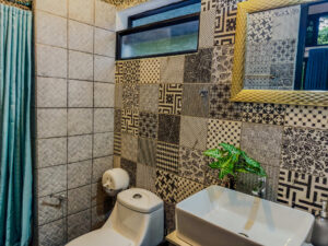 Ensuite shared bathroom with patterned tile in Isla Mujeres female dorm