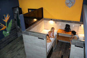 Female dorm beds with individual spaces and shared fan in Isla Mujeres riverfront dorm