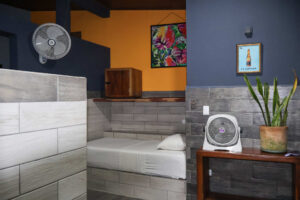 Cozy individual dorm bed with fan and storage in Isla Mujeres female dorm