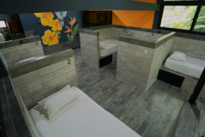 Modern individual dorm beds with privacy walls and storage in Isla Mujeres female dorm
