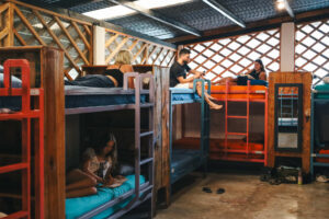 Open-air mixed dorm room with colorful bunk beds above the bar at Greengo’s Guatemala