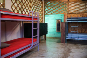 Shared dorm room with colorful bunk beds and open-air design in the Noisy Dorm