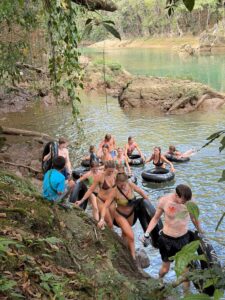 Travelers floating down the Cahabón River during Extreme Tubing adventure in Guatemala