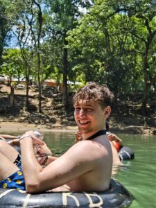 Guest relaxing in river tube surrounded by jungle scenery during Extreme Tubing tour