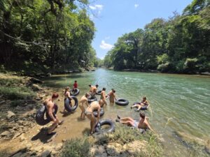 Travelers entering the Cahabón River for white-water tubing adventure in Guatemala