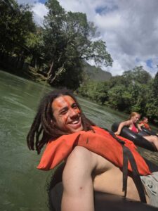 Guest floating through jungle river rapids during Extreme Tubing tour near Greengo’s