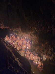 Large group exploring underground chambers inside K’anba Cave near Semuc Champey