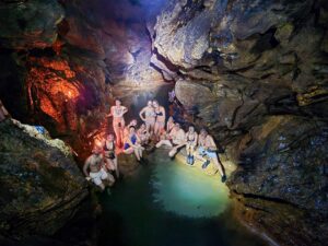 Natural underground pool inside K’anba Cave during guided cave tour in Guatemala