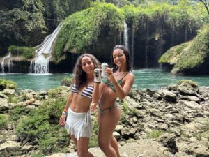 Travelers visiting jungle waterfall and natural pools during K’anba Cave Tour in Guatemala