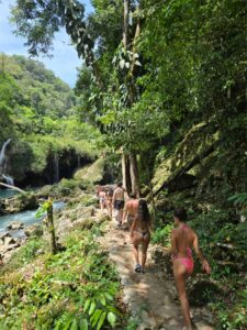 Jungle waterfall and natural swimming area visited during K’anba Cave Tour