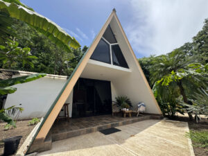 A-frame Garden Cabaña exterior surrounded by jungle at Greengo’s Hotel Guatemala