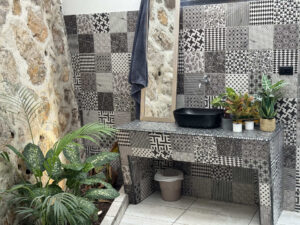 Stone private bathroom with open jungle-inspired design in Garden Cabaña