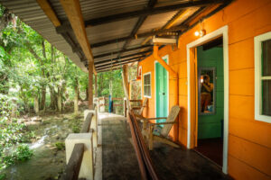 Exterior walkway and balcony access to Riverside Rooms beside the jungle