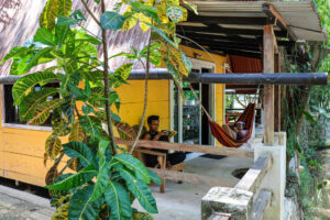 Exterior of original Riverside Rooms with hammocks overlooking the river at Greengo’s Guatemala