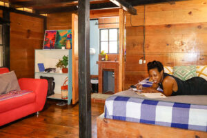 Simple wooden private room with fan and private bathroom in Riverside Rooms
