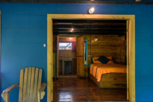 Colorful Riverside Room interior with queen bed and jungle lodge atmosphere