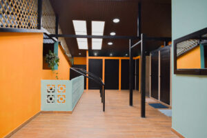 Open-air communal bathroom area in El Barrio with modern tropical design