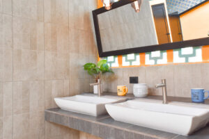 Modern shared bathroom sinks and mirrors in El Barrio at Greengo’s Hotel