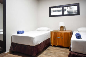 Twin room setup inside El Barrio semi-private accommodations at Greengo’s Hotel