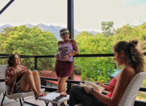 Guests relaxing on jungle-view balcony outside Nomads semi-private rooms at Greengo’s