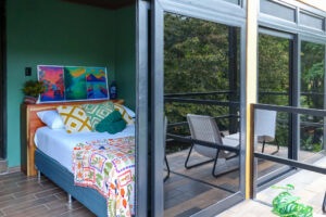 Compact Nomads room with private balcony and jungle mountain views at Greengo’s Guatemala