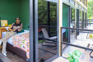 Single bed Nomads room with balcony and tropical jungle surroundings