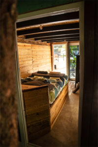 Rustic wooden double bed room inside Cozy Nooks at Greengo’s Guatemala