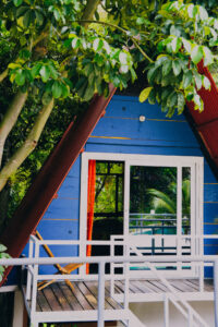 Colorful PoolFront Loft exterior with balcony and jungle surroundings at Greengo’s